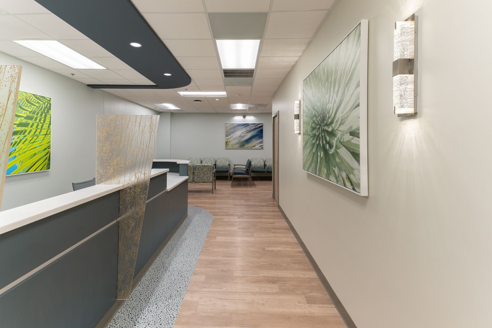 Reception approach with textured glass panel and wall sconces